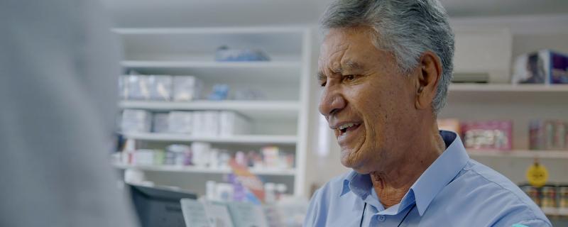 Image of an older Māori man in a pharmacy