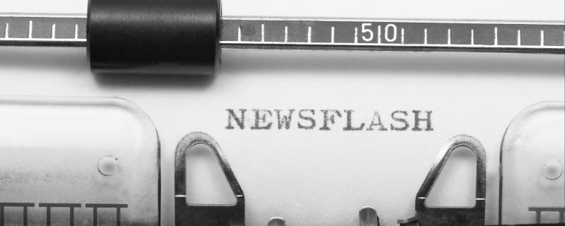 Typewriter typing the word "newsflash"